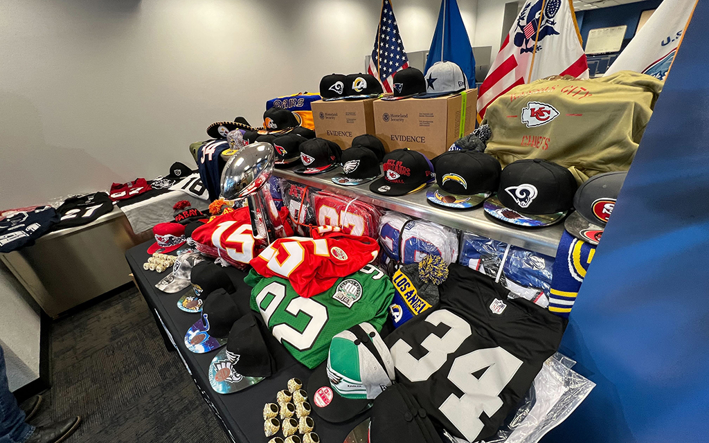 The Department of Homeland Security shows counterfeit merchandise, including NFL jerseys, hats and rings. (Photo by John Brown/Cronkite News)