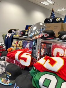 The Department of Homeland Security shows a Vince Lombardi Trophy that is fake, along with other NFL jerseys, hats and other counterfeit merchandise. (Photo by John Brown/Cronkite News)