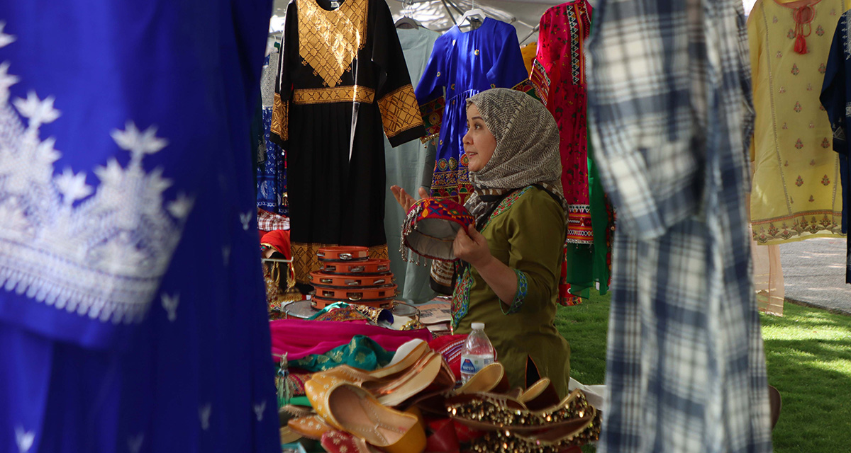 Taiba Hussain showcases clothes and jewelry at the Nowruz Phoenix celebration on March 18, 2023. (Photo by Paula Soria/Cronkite News)
