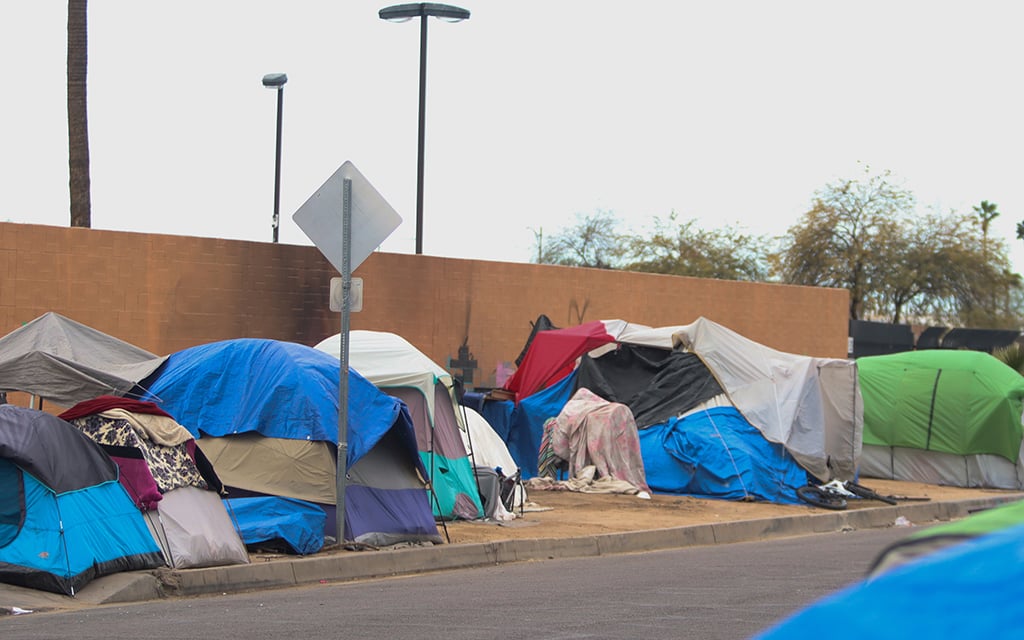 Tents used as temporary living spaces are set up on West Madison Street in “The Zone,” the area surrounding the Human Services Campus in Phoenix on March 1, 2023. (Photo by Logan Camden/Cronkite News)