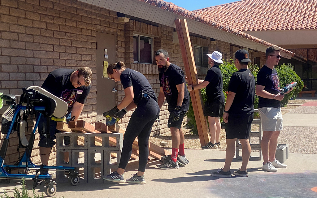 Arizona Coyotes front office staff recently helped out at ACCEL school for Cesar Chavez Day by building and doing other activities, including painting and sanding. (Photo by Haley Smilow/Cronkite News)