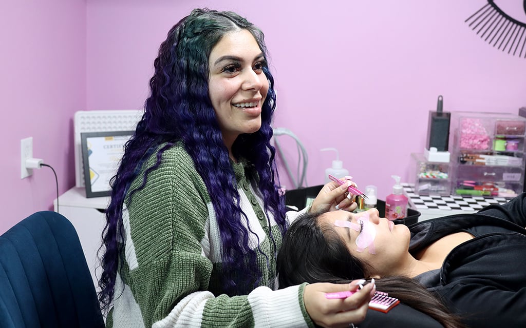 Raquel Solis, owner of Lash Bottega Salon, works on client Paola Alvarez's eyelashes on March 13, 2023, in Phoenix. (Photo by Izabella Hernandez/Cronkite News)
