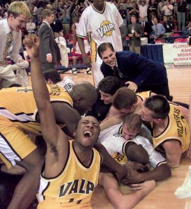 Bryce Drew, buried under his teammates, collapsed to the floor after the winning shot. Valparaiso won one more game in the NCAA Tournament, over Florida State. (Photo courtesy of Valparaiso Athletics)