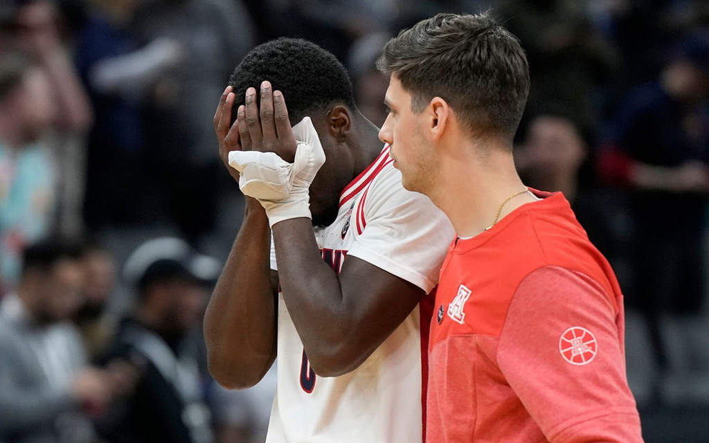 Arizona’s Courtney Ramey hides his face in his hands after the Wildcats were upset by the Princeton Tigers in the first round of the NCAA Men’s Basketball Tournament at Golden 1 Center in Sacramento, Calif. (Photo by Thearon W. Henderson/Getty Images)