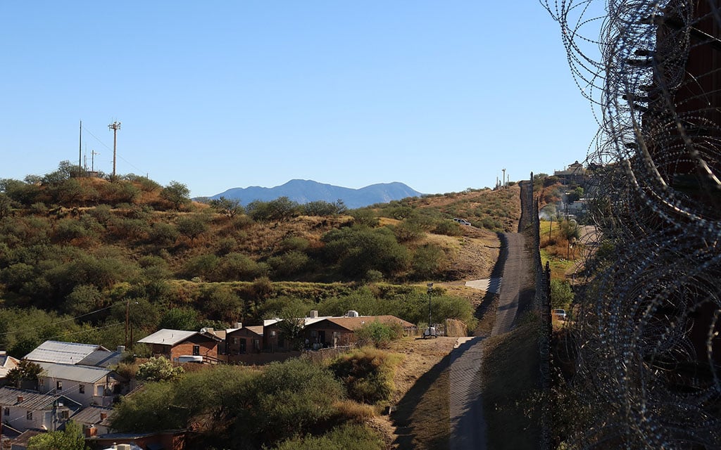 Two remote video surveillance systems are shown on hills across from the border wall in Nogales, Ariz. (Photo courtesy of Electronic Frontier Foundation)
