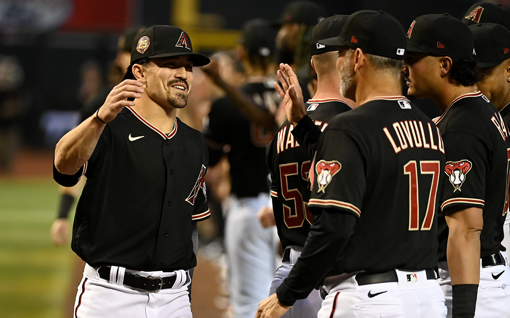 Arizona Diamondbacks outfielder Corbin Carroll, left, went 0-for-4 in Thursday's 5-2 loss to the Los Angeles Dodgers. Manager Torey Lovullo plans to ease the 22-year-old into the majors before rushing him into the leadoff spot. (Photo by Norm Hall/Getty Images)