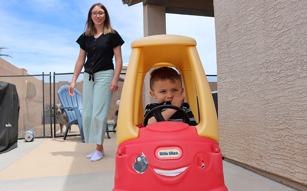 Jude Wentland plays with his mom, Madison Wentland, outside their home. (Photo by Lauren Kobley/Cronkite News)