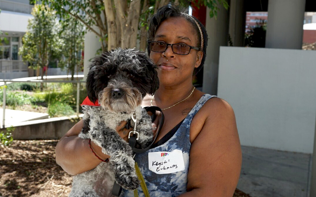 Krystal Eubanks shared her story at the My Dog is My Home co-sheltering conference. Her dog Keeper is in training to be a service dog (Photo by Ayana Hamilton/Cronkite News)