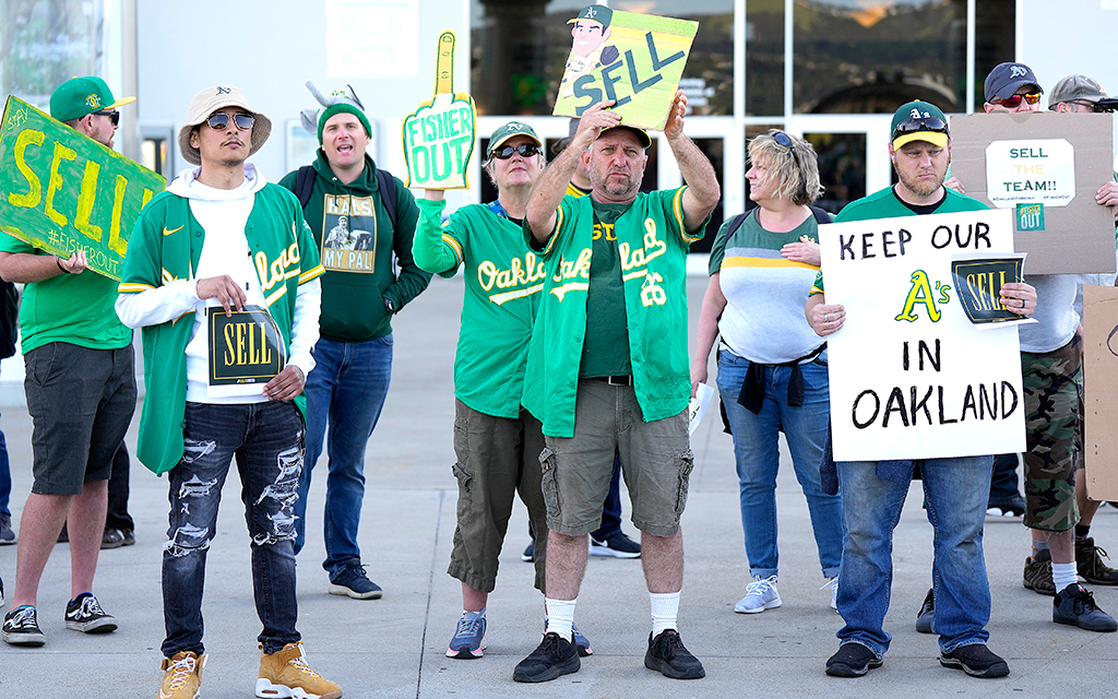 With the decision to move from Oakland to Las Vegas, fans of the Athletics protest with signs outside the stadium before the start of the game against the Cincinnati Reds at RingCentral Coliseum in Oakland. (Photo by Thearon W. Henderson/Getty Images)
