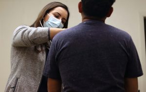 Doctora Mariela Lane,, profesora de TTUHSC, examina a paciente migrante de Honduras durante su consulta médica en la clínica de El Paso, Texas, el día jueves 30 de marzo de 2023. (Foto por Paula Soria/Cronkite Noticias)
