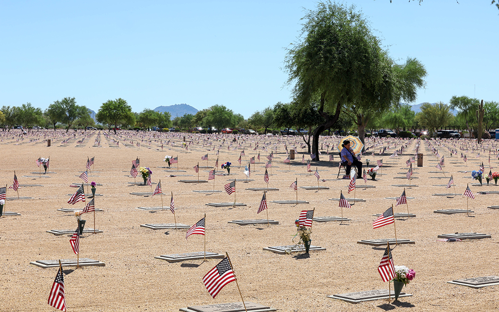 For many, Memorial Day is spent remembering fallen service members. Those who gathered at the National Memorial Cemetery of Arizona Monday witnessed the celebration that takes place each year Thousands of volunteers place flags on each graveyard to celebrate the life of each individual. (Photo By Evelin Ruelas/Cronkite News)