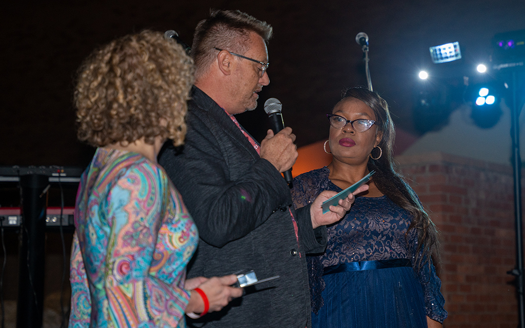 Tamika Broadnax, right, receives the Tempe Community Action Agency's Barbara Norton Award for her perseverance through homelessness and her impact on the community at an April 14, 2023, fundraising event. (Photo by Jack Wu/Cronkite News)