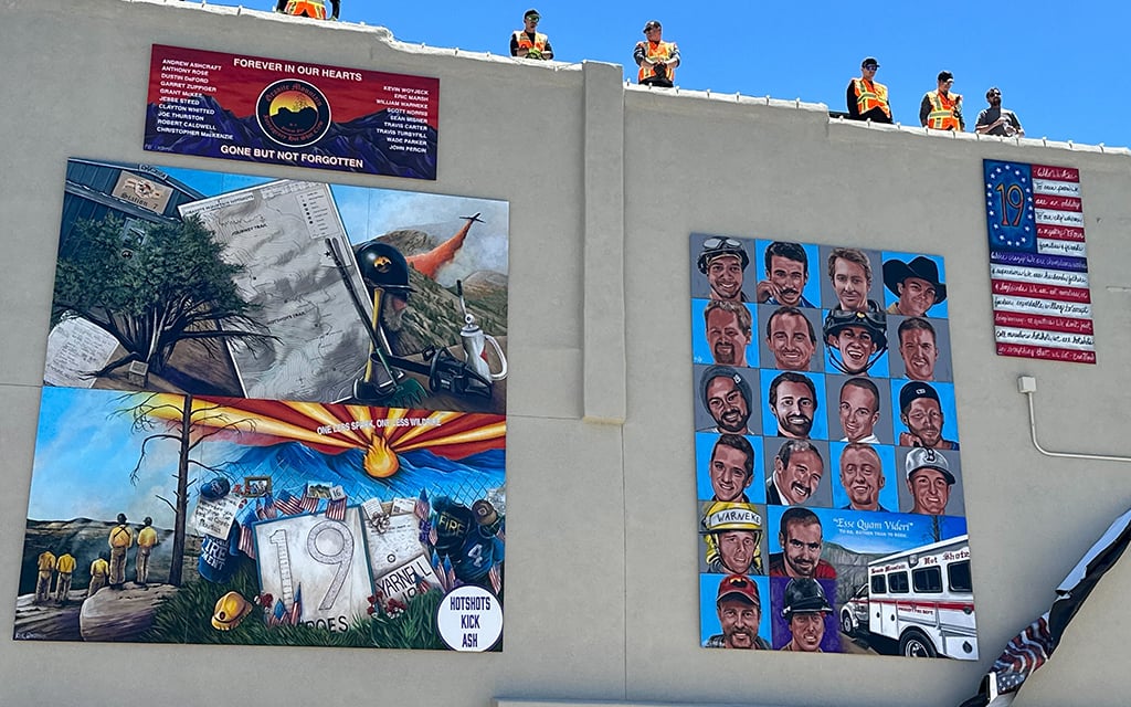 A mural created by Arizona artist Katie Von Kral honors the bravery of the Granite Mountain Hotshots and captures the essence of their courage. Unveiled Wednesday, June 28, 2023, the artwork is on the Prescott Chamber of Commerce building. (Photo by Bri Pacelli/Cronkite News)