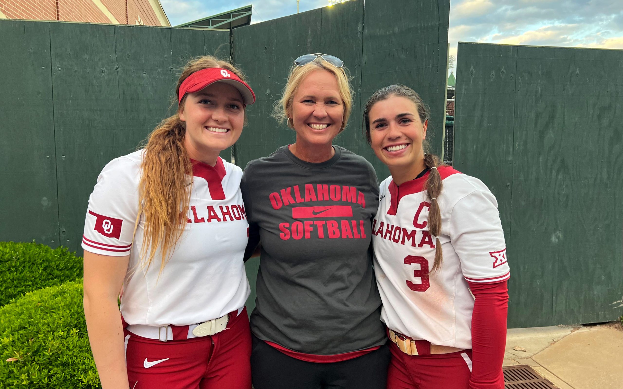 Jocey Erickson (left), Coach Hobson (center) and Grace Lyons (right) reunited at Getterman Stadium in Waco, Texas for a game against Baylor. (Photo courtesy of David Erickson, Jocey’s father)