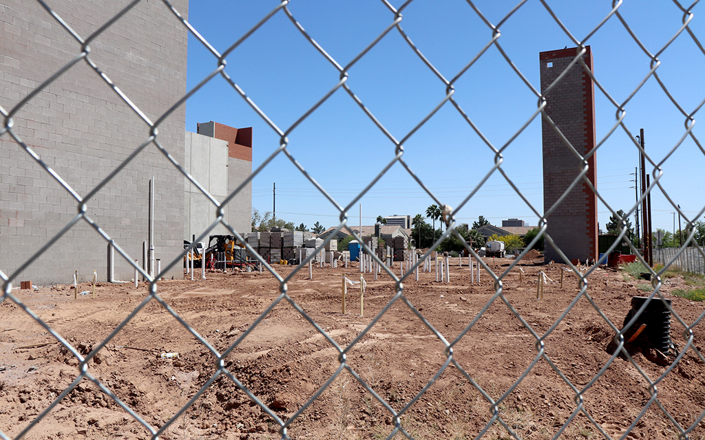 Construction is underway at the Aura Trinsic development site on Third Avenue and Coolidge Street, seen here on April 26, 2023. (Photo by Emma Peterson/Howard Center for Investigative Journalism)