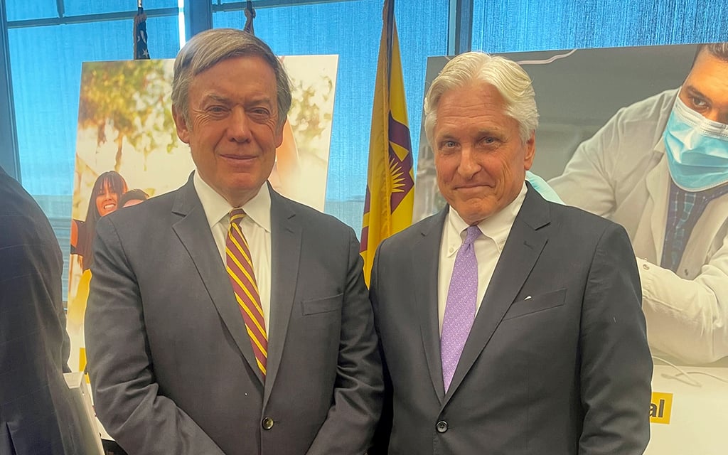 ASU President Michael Crow, left, and Fred DuVal, chair elect of the Arizona Board of Regents, confer after the regents meeting where Crow announced a new medical school on Thursday, June 1, 2023. (Photo by Sophia Biazus/Cronkite News)