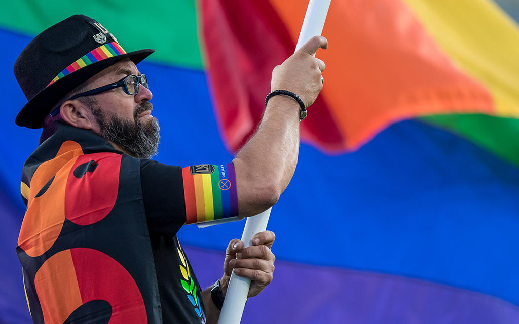 Amidst pushback, enthusiastic fans proudly display their rainbow flags at a vibrant Pride Night celebration, demonstrating solidarity and support for LGBTQ+ representation in sports. (Photo by Shaun Clark/Getty Images)