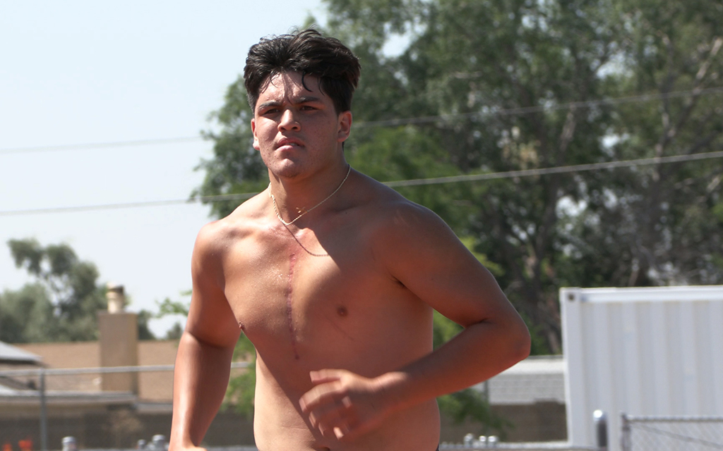Only six months removed from heart surgery in January, Raymond Jones pushed through running drills on the Cactus High School track to prepare for his senior season. (Photo by Eduardo Morales/Cronkite News)