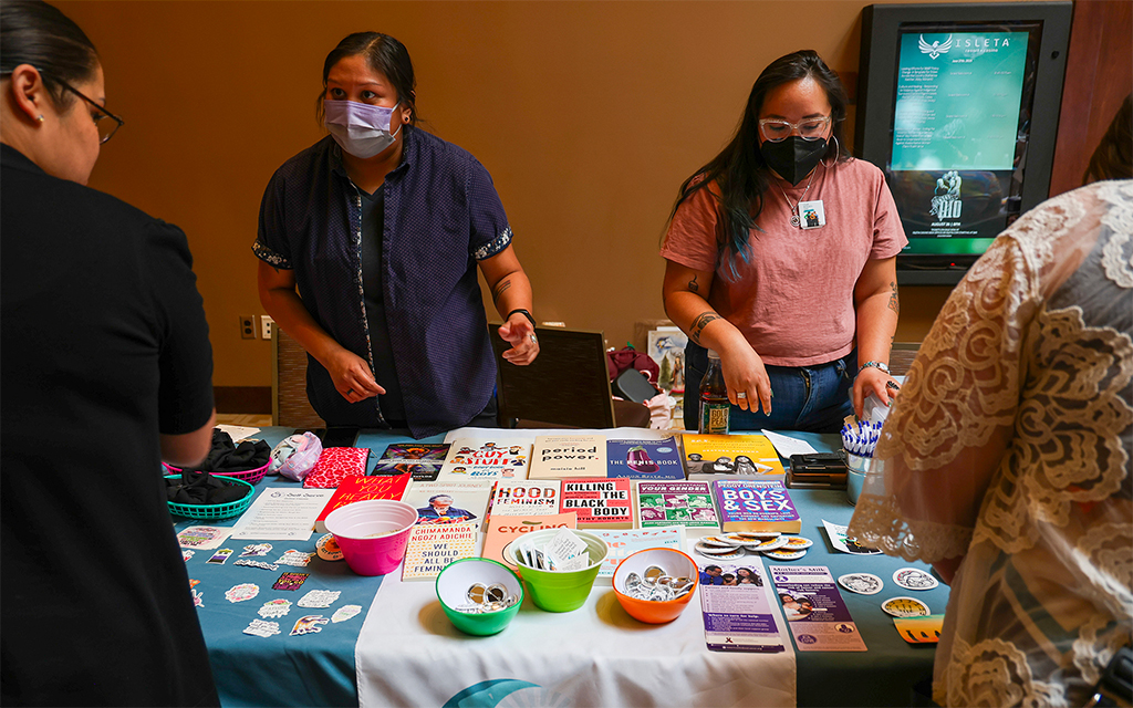 Sandy Harris, left, and Jonnette Paddy, right, with Indigenous Women Rising talk about abortion care and reproductive health with attendees at the “Women Are Sacred” conference on June 27, 2023, in Albuquerque, N.M. (Photo by Noel Lyn Smith/News21)