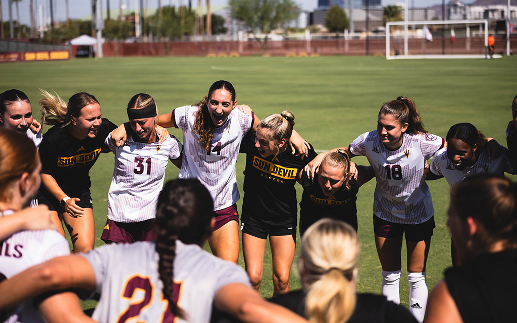 ASU Women's soccer players in a team huddle.