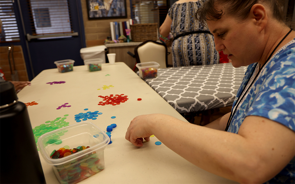Kathleen Allen sorts colored counting chips at the FSL ReCreación Center in Tempe