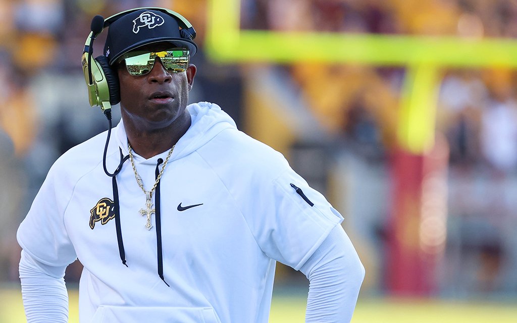 Colorado football coach Deion Sanders looks at the scoreboard during a game against ASU at Mountain America Stadium in Tempe on Oct. 7, 2023. (Photo by Reece Andrews/Cronkite News)