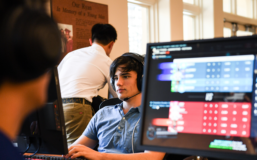 Brophy student focusing on his computer screen.