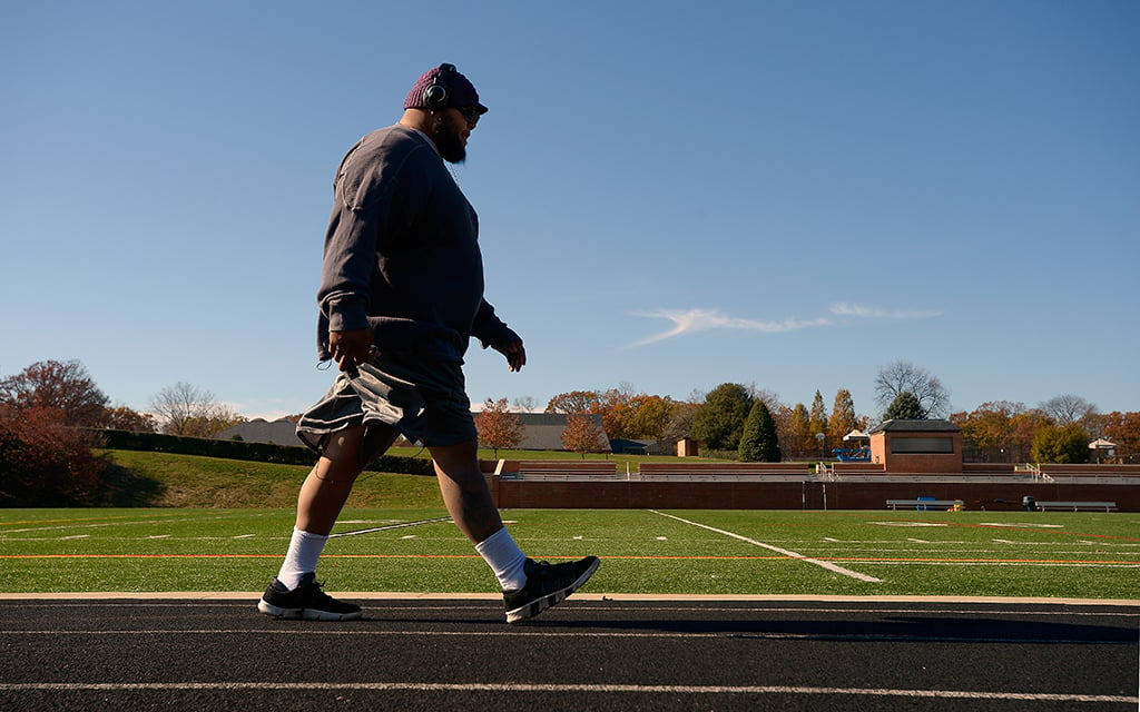 Former Washington Redskin offensive lineman Tre Johnson frequently takes a 3-mile walk around the track during his break from teaching at Landon School in Bethesda, Maryland. He once weighed over 400 pounds. (Photo by John McDonnell/The Washington Post via Getty Images)