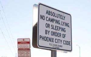 The area between downtown Phoenix and the Capitol known as “The Zone” has various “no trespassing” and “no camping” signs. The Zone was a sprawling encampment of over 1,000 people experiencing homelessness, but the city of Phoenix was ordered to clear out tents and structures by Nov. 4. (Photo by Hunter Fore/Cronkite News)