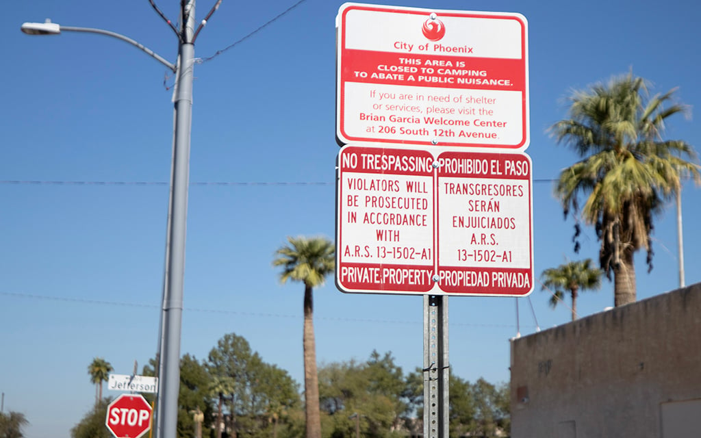A sign at 13th Avenue and Jefferson Street, next to Old Station Sub Shop, declares the area is “closed to camping.” (Photo by Hunter Fore/Cronkite News)
