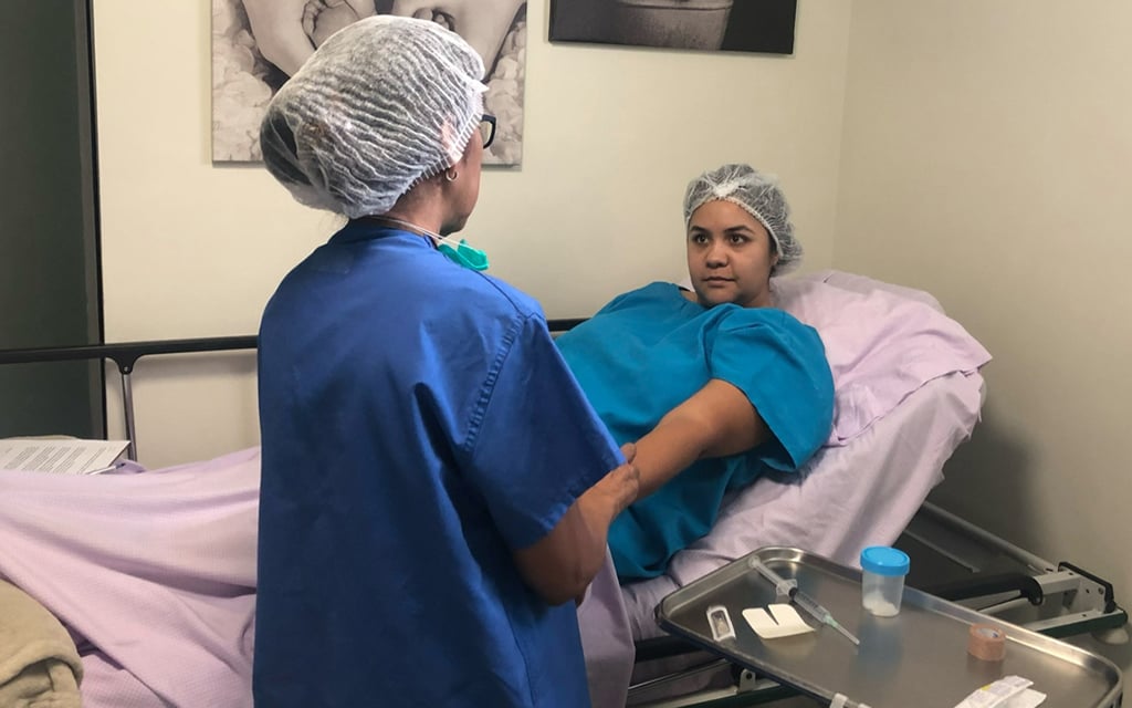 A Dr. Cigüeña staff member prepares Cristina Yanez for the transfer of embryos on Aug. 27, 2019. (Photo courtesy of Cristina Yanez)