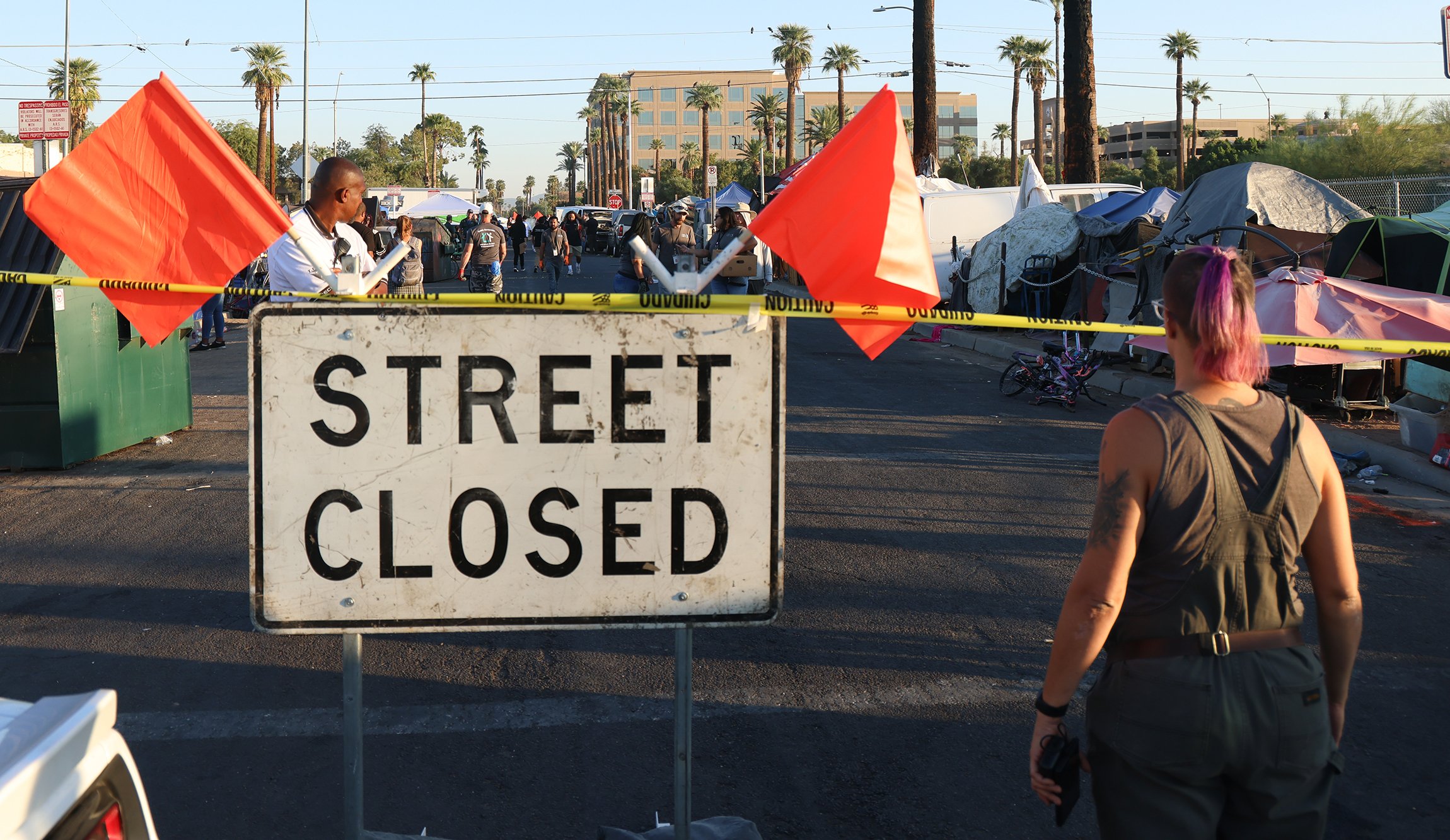 Officials from the city of Phoenix block off 12th Avenue between Jefferson and Madison streets on the morning of Oct. 20 to facilitate the clearing of a homeless encampment under a court order issued earlier this year. (Photo by John Leos/Cronkite News)

