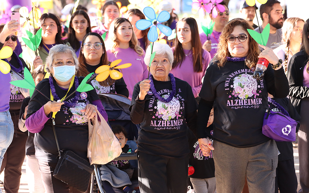 Participants in the annual Walk to End Alzheimer’s in Laredo at Texas A&M International University on Nov. 4. Blue flowers are held by those living with Alzheimer’s. (Photo by Angelina Steel/Cronkite News)