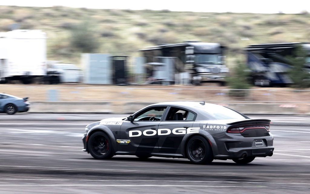 Passengers enjoy the adrenaline-pumping experience of drifting in a Dodge Challenger at the Radford Racing School course at the Barrett-Jackson car auction. (Photo by Joe Eigo/Cronkite News)