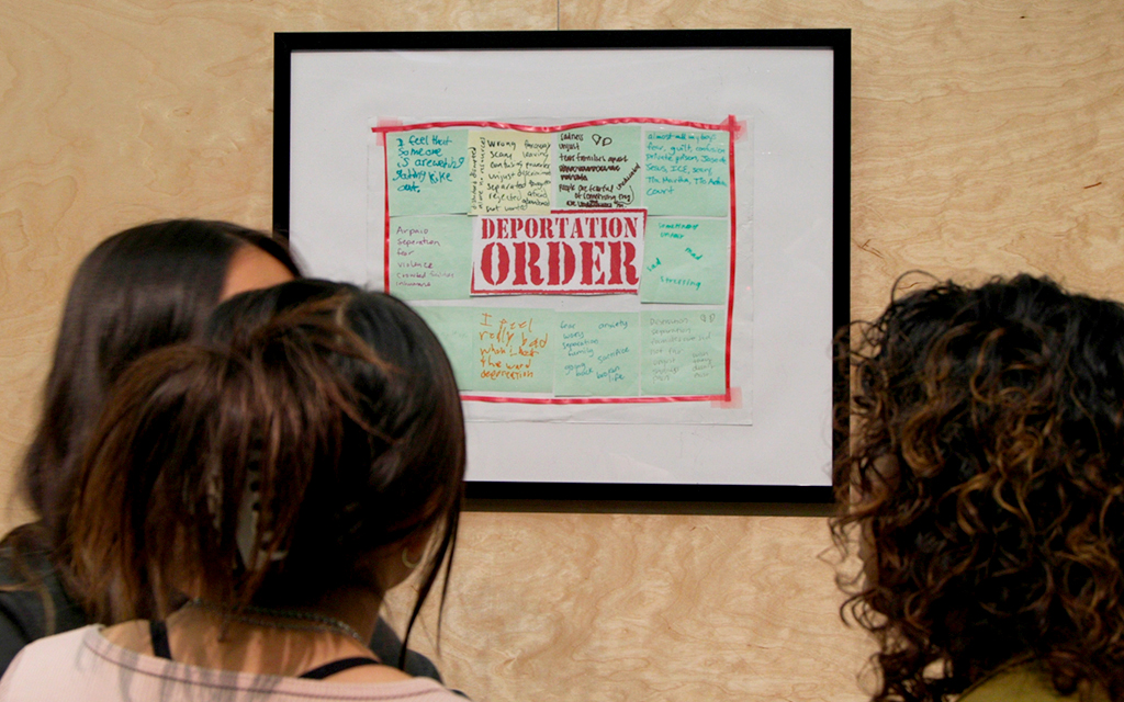 Organizers at Aliento, a Phoenix-based nonprofit providing wellness resources to undocumented youth and DACA recipients, display artistic works created by participants of their wellness programs at their annual art gallery on November 3, 2023. (Photo by John Leos/Cronkite News)
