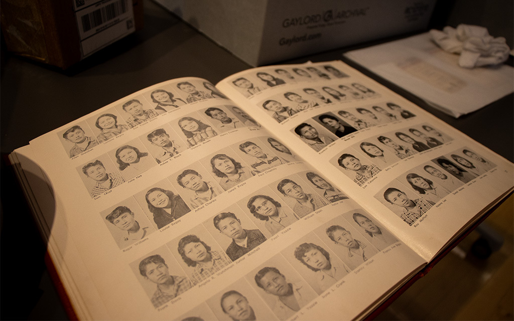 A yearbook with the faces of those who attended Phoenix Indian School in the 1950s in the archives at the visitor center at the old Phoenix Indian School building. (Photo by Ellie Willard/Cronkite News)
