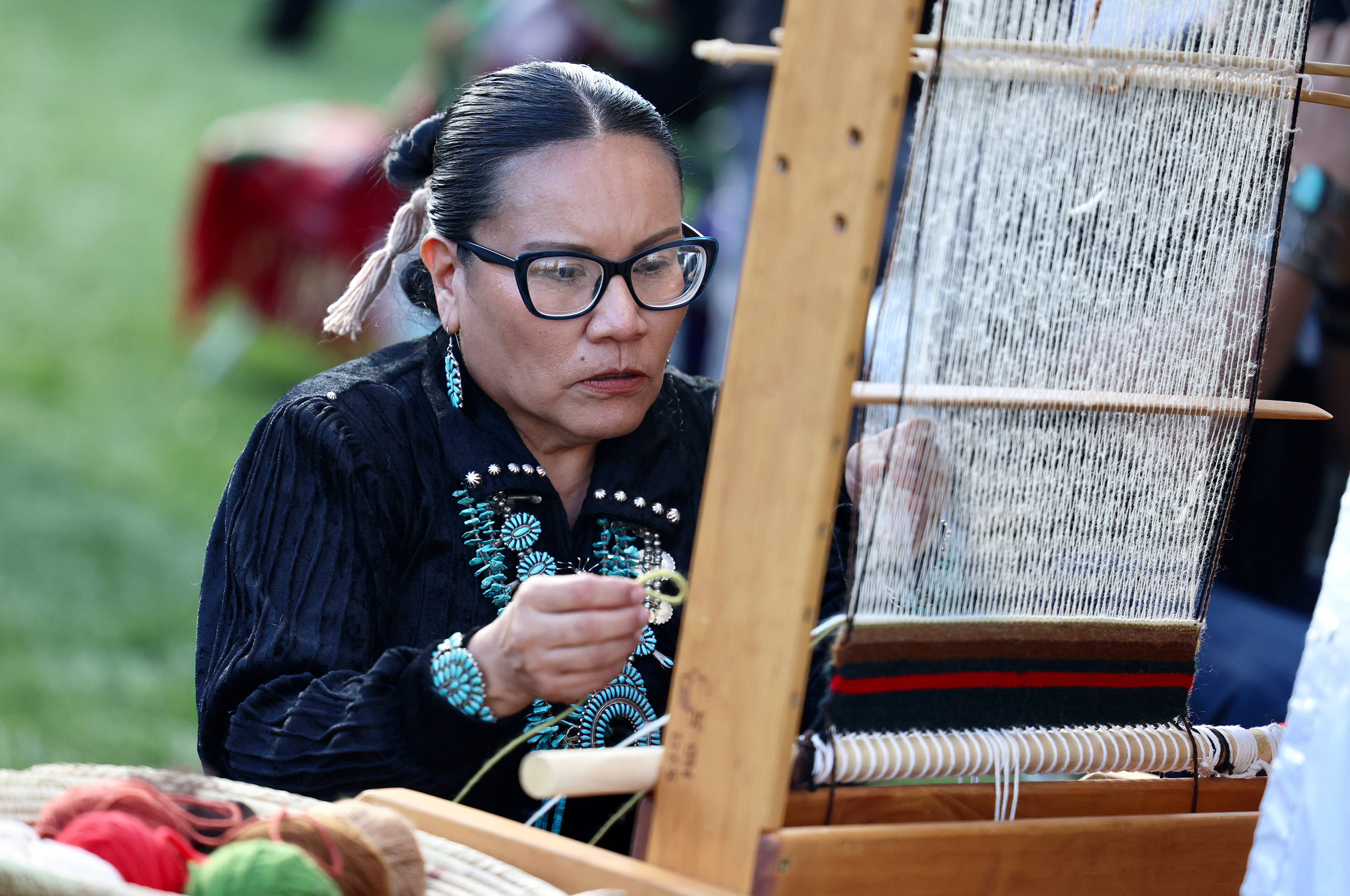 Sonja Morgan from the Navajo Nation showcases her rug-weaving process at the Arizona Indian Festival in Scottsdale on Feb. 3, 2024. (Photo by Marnie Jordan/Cronkite News)
