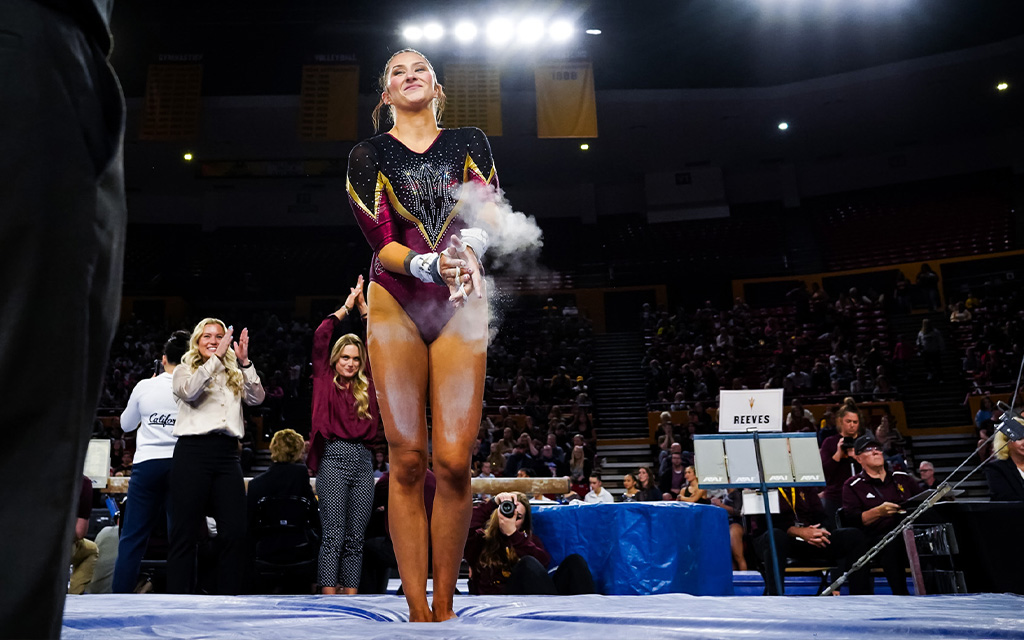 ASU graduate student gymnast Gracie Reeves celebrates after successfully dismounting from the uneven bars Feb. 2 at the Maroon Monsoon Tri-Meet. (Photo courtesy of Sun Devil Athletics)