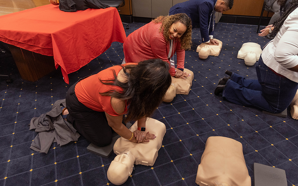 Jennifer Stingley, middle, is a member of the American Heart Association’s southern Arizona board of directors. Stingley practices CPR at the Arizona Heart Association’s annual lobby day at the Arizona Capitol on Feb. 7, 2024. (Photo by Sam Ballesteros/Cronkite News)