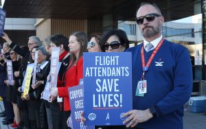 John Sas, right, a flight attendant for United Airlines, advocates for a new contract on Feb. 13, 2024, at Phoenix Sky Harbor International Airport. (Photo by Mariah Temprendola/Cronkite News)