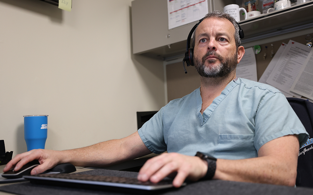 Bryan Kuhn works at his desk in the Banner Health toxicology department, on Feb. 5. As naloxone becomes more widespread, he says that people may not be prepared for what happens after using it to revive someone. (Photo by Jack Orleans/Cronkite News)