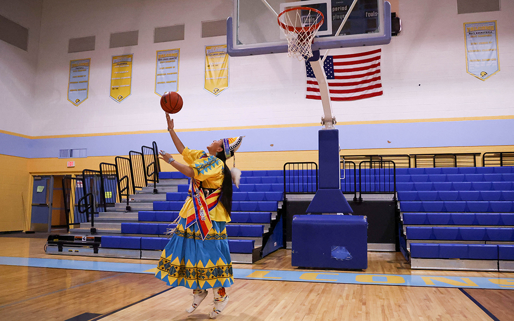 Laney Lupe, an Alchesay girls basketball alum and Miss Indian Arizona 2023-24, shoots a reverse layup at Chief Alchesay Activity Center in Whiteriver. (Photo by Reece Andrews/Cronkite News)