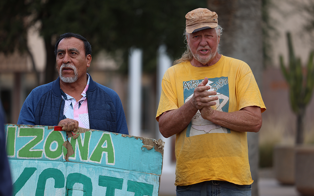 Jorge Flores, left, and Rob McElwain clap and chant “no somos ilegales, no somos criminales” – “We are not illegal, we are not criminals” – along with the other protesters at the Arizona State Capitol on Feb. 1, 2024. (Photo by Marnie Jordan/Cronkite News)