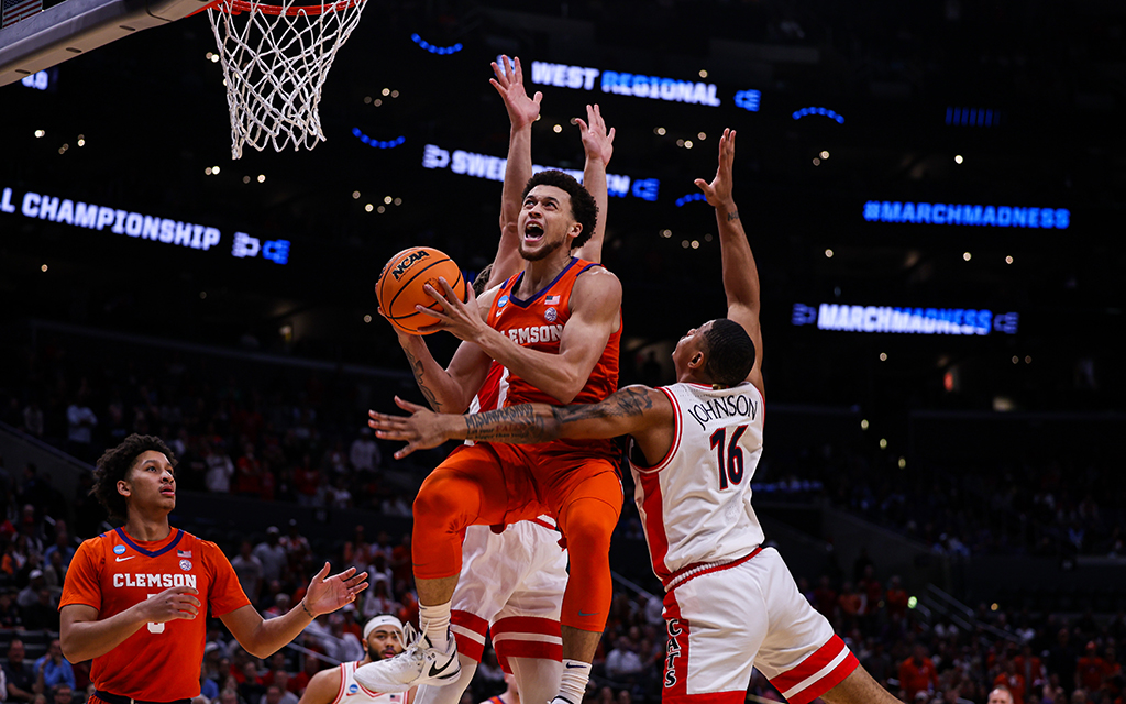 Clemson senior guard Chase Hunter drives through defenders for a contested layup, contributing to his team-high 18 points in the Tigers' victory over Arizona in the men's NCAA Tournament in Los Angeles. (Photo by Bennett Silvyn/Cronkite News)