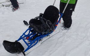 The Bi Ski from High Country Adaptive Sports allows for independent skiing and has handheld outriggers for balancing and turning. (Photo by Philip Leavell/Cronkite News)