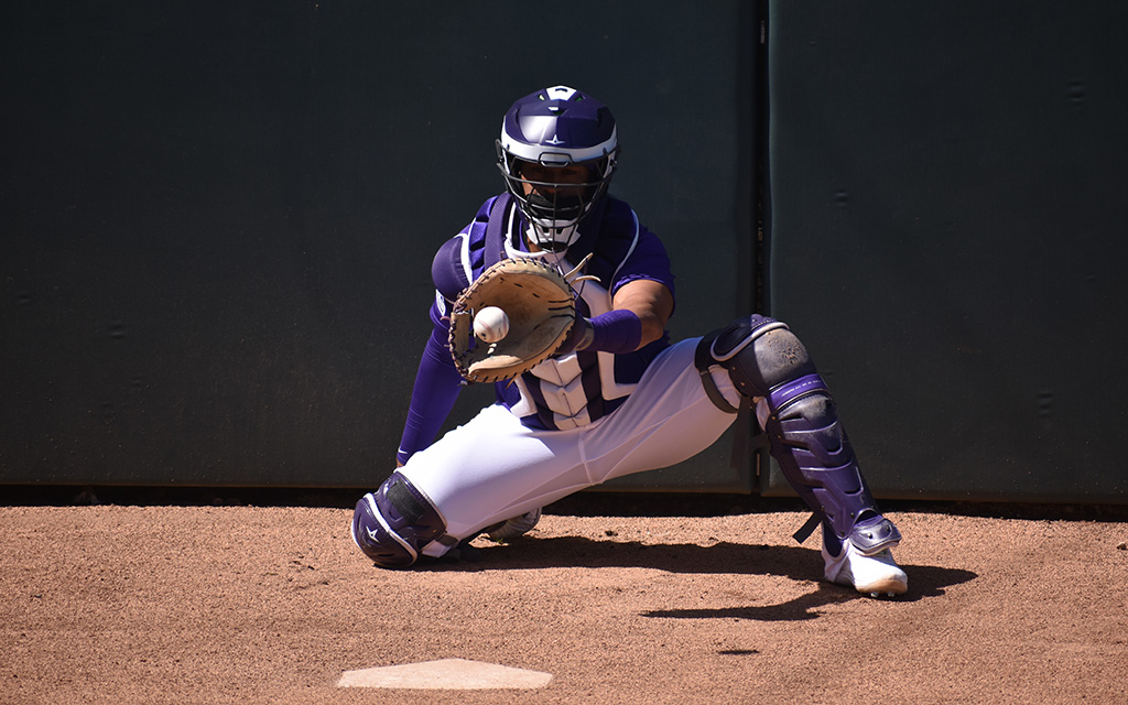 Catcher Elias Diaz hauls in some pregame pitches from behind the plate, but inside the batter's box is where the Rockies have been most dangerous during spring training. (Photo by Brett Lapinski/Cronkite News)