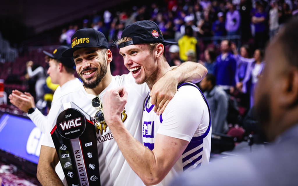 GCU teammates Gabe McGlothan, left, and Duke Brennan celebrate with the WAC Tournament trophy. The Lopes open NCAA Tournament play Friday in Spokane, Washington. (Photo by Dominic Contini/Cronkite News)
