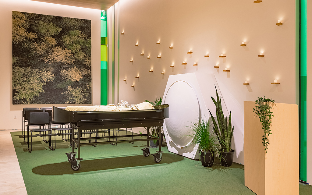 The Recompose gathering space is where laying-in funeral ceremonies takes place. The body, shrouded in natural cloth, lies on a dark green bed called the cradle. (Photo courtesy of Recompose)