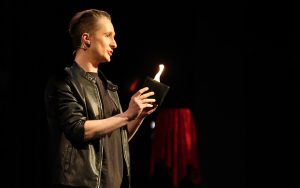 Magician Ben Zabin shows the “Smokus Pocus” audience a flaming wallet on March 1, 2024, at Third Street Theater in Phoenix. (Photo by Marnie Jordan/Cronkite News)