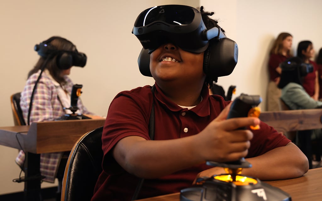 Hassan Davis smiles as he immerses himself in virtual learning on March 28, 2024, in Phoenix. ASU Prep Pilgrim Rest unveiled its Dreamscape Learn Pod, the first virtual learning experience of its kind for K-12 students in the country. (Photo by Kevinjonah Paguio/Cronkite News)